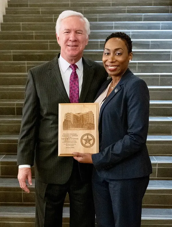 Acting U.S. Marshal Lasha Boyden holding an award